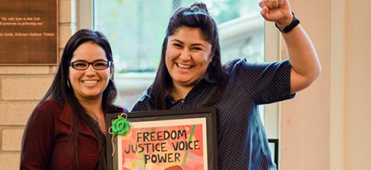GSSW graduate students pose with a sign that says Freedom Voice Justice Power