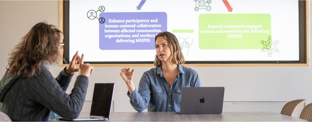 a professor and a student discussing in a meeting room