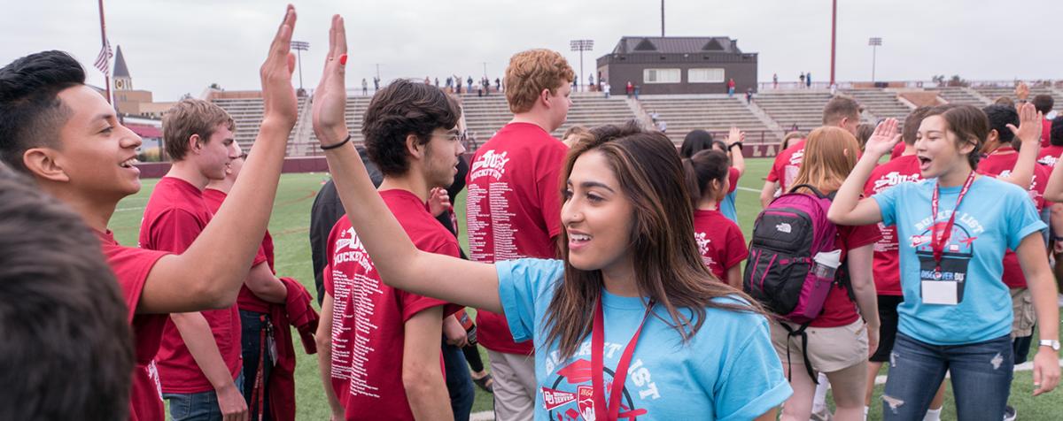 Students high-five at orientation