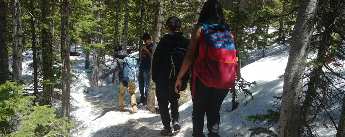 students hiking with gear from gear garage