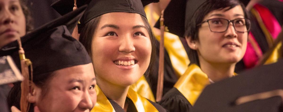smiling students in graduation attire
