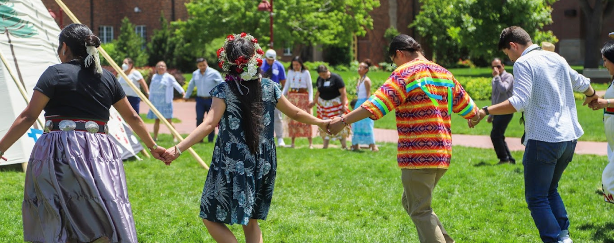 People holding hands in a round dance