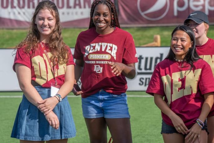 students watch outdoor athletics event