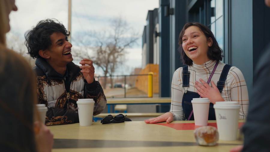 two students laughing over coffee