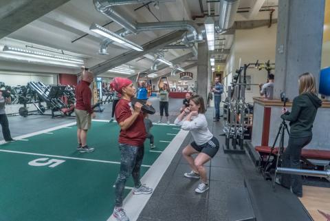 People doing weight lifting in a gym