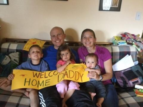 Brad Davidson with his family after arriving home