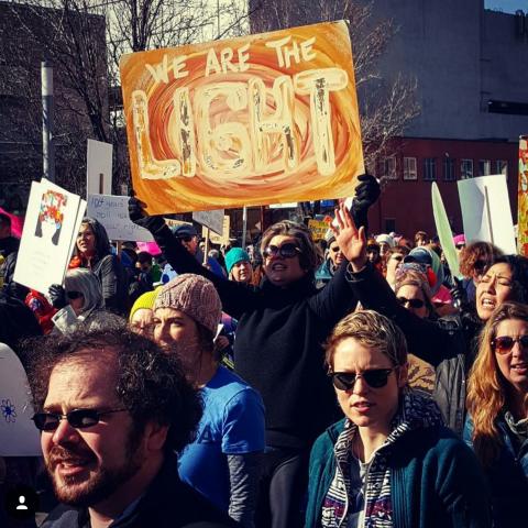 Jami Duffy holds a protest sign at a rally