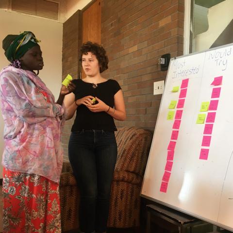 Two women at white board with post-it notes