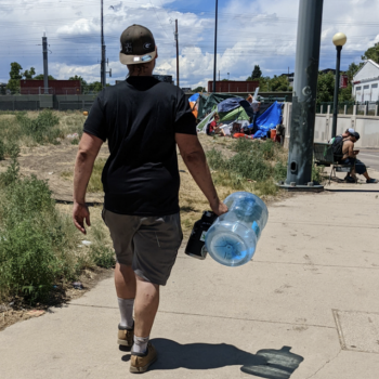 person carrying water jug