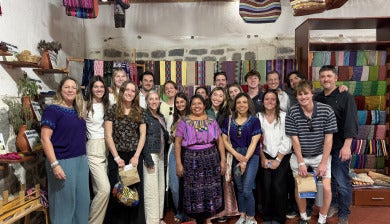 A group of DU students posing in a shop in Guatemala during an interterm trip