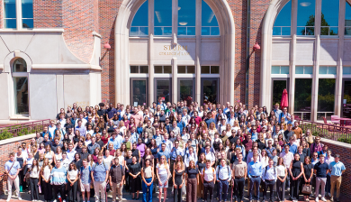 More than 200 incoming students stand for a group photo outside the Ricketson Law Building.