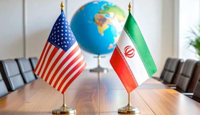 empty boardroom with US and Iranian flags sitting on the table with out of focus globe in background