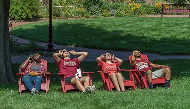 Members of the DU community look up at the solar eclipse