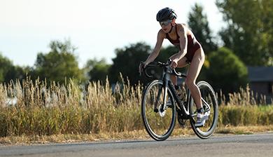 Freya McKinley riding a bike during a triathlon
