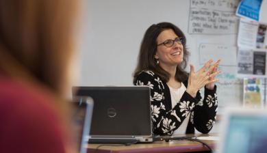 Stacey Freedenthal speaks animatedly in a classroom.