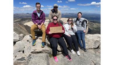 Jon Velotta and his students researchers sit at the top of Mt Blue Sky, formerly known as Mt. Evans.