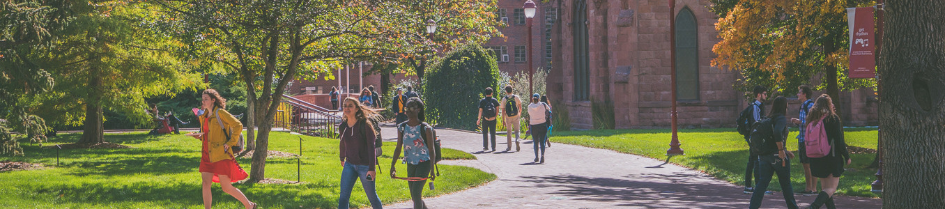 students walking through campus during the early fall