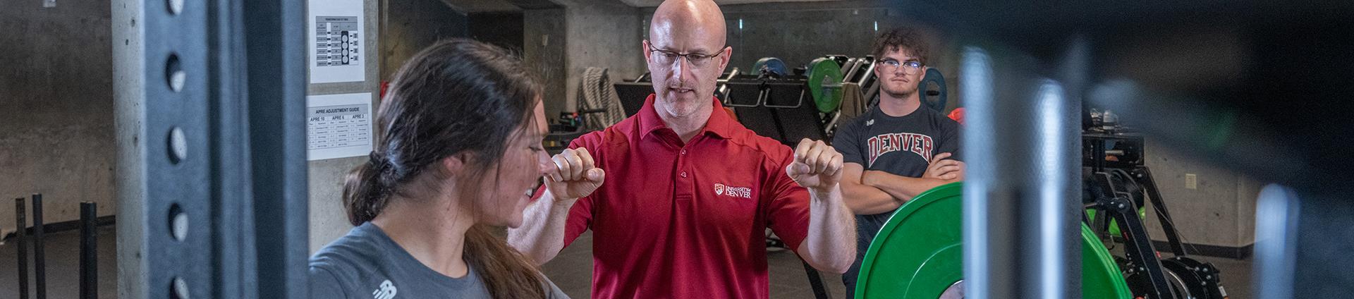 Brian Gearity coaches students on weight training