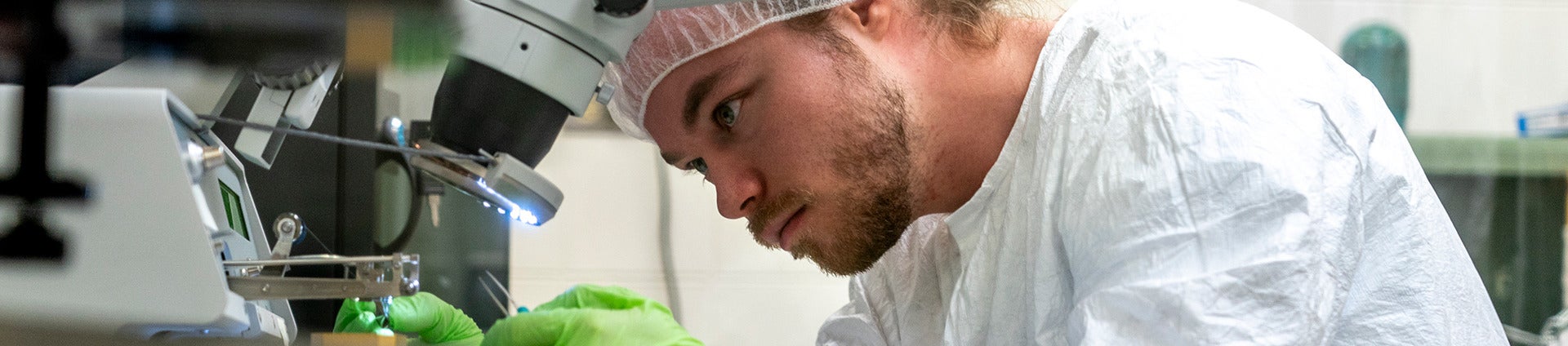 a student using microscope in lab