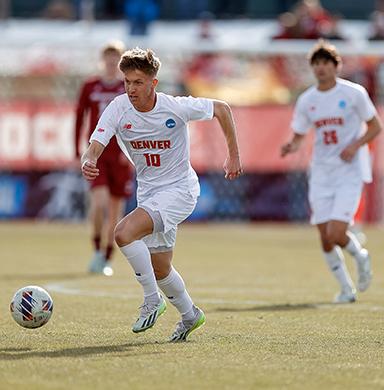 Sam Bassett runs toward the soccer ball.