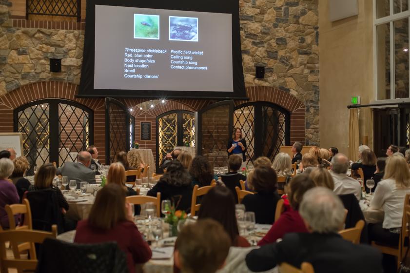 Presenter speaking with slides