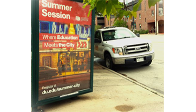 summer session advertisement next to a car