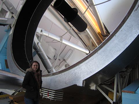 woman-standing-telescope-mirror