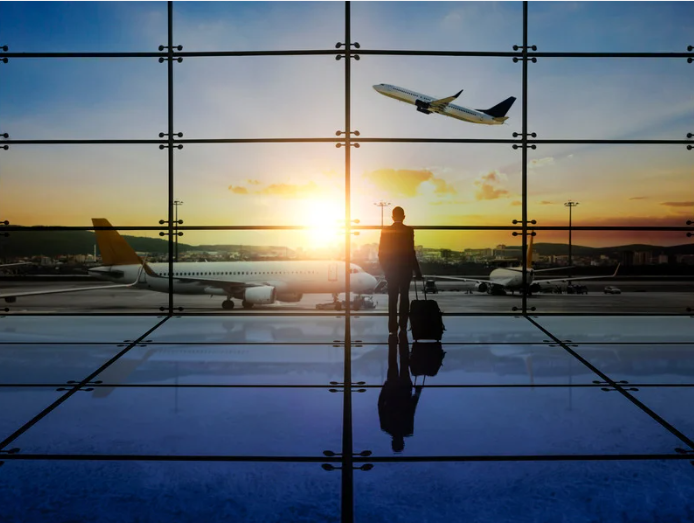 traveler watching plane depart from terminal